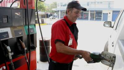 Un bombero de una gasolinera sampedrana llena el tanque de combustible de un pick up. Foto: Jorge Gonzales