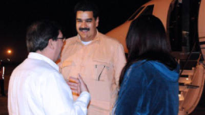 In this photo provided by Cuba's state newspaper Granma, Cuban Foreign Minister Bruno Rodriguez , left, talks with Venezuela's Vice President Nicolas Maduro, center, as Venezuelan Attorney General Cilia Flores watches at the Jose Marti International Airport in Havana on Saturday, Dec. 29, 2012. Maduro arrived in Cuba to visit Venezuelan President Hugo Chavez, who is recovering from a surgery_ his fourth operation related to his pelvic cancer since June 2011. (AP Photo/Granma, Juvenal Balan Neyra )