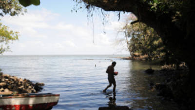 This file picture shows a man wading through the water in Taguizapa beach at Ometepe Island in Lake Nicaragua, south from Managua, on February 29, 2011. Nicaraguan lawmakers on Thursday approved a controversial deal that would allow a Hong Kong company to build a $40 billion oceanic waterway to rival the Panama Canal, and then manage it for the next 50 years. Environmental activists fear the worst for Lake Nicaragua, which the planned waterway will pass through. AFP PHOTO/ ELMER MARTINEZ