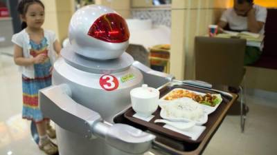 Un robot sirve comida en un restaurante chino.