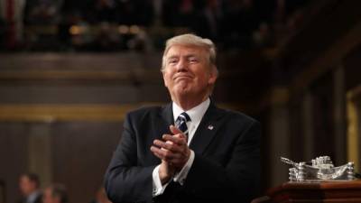 US President Donald J. Trump reacts after delivering his first address to a joint session of Congress from the floor of the House of Representatives in Washington, DC, USA, 28 February 2017. / AFP PHOTO / POOL / JIM LO SCALZO