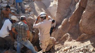 Bomberos al momento de excavar para sacar el cuerpo.