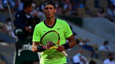 Spain's Rafael Nadal reacts as he plays against Italy's Jannik Sinner during their men's singles fourth round tennis match at Court Suzanne Lenglen on Day 9 of The Roland Garros 2021 French Open tennis tournament in Paris on June 7, 2021. (Photo by MARTIN BUREAU / AFP)