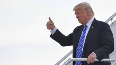 US President Donald Trump (C) walks out of Air Force One upon his arrival in John F. Kennedy International Airport in New York, on September 26, 2017. Trump is in New York to visit the US Mission to the United Nations and to attend fundraisers. / AFP PHOTO / MANDEL NGAN