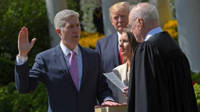El juez Neil Gorsuch presta juramento como magistrado de la Corte Suprema de los Estados Unidos en el jardín de la Casa Blanca. Observa como testigo el presidente Donald Trump.