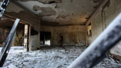 A Libyan man walks in the rubble of the damaged U.S. consulate, after an attack that killed four Americans, including Ambassador Chris Stevens on the night of Tuesday, Sept. 11, 2012, in Benghazi, Libya, Thursday, Sept. 13, 2012. The American ambassador to Libya and three other Americans were killed when a mob of protesters and gunmen overwhelmed the U.S. Consulate in Benghazi, setting fire to it in outrage over a film that ridicules Islam's Prophet Muhammad. Ambassador Chris Stevens, 52, died as he and a group of embassy employees went to the consulate to try to evacuate staff as a crowd of hundreds attacked the consulate Tuesday evening, many of them firing machine-guns and rocket-propelled grenades. (AP photo/Mohammad Hannon)