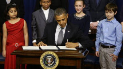 From left to right: Hinna Zeejah, 8, Taejah Goode, 10, Julia Stokes, 11, and Grant Fritz, 8, who wrote letters to President Barack Obama about the school shooting in Newtown, Conn., watch as Obama signs executive orders outlining proposals to reduce gun violence, Wednesday, Jan. 16, 2013, in the South Court Auditorium at the White House in Washington. (AP Photo/Charles Dharapak)