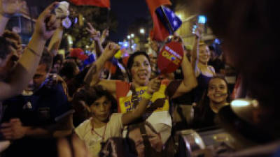 Supporters of Venezuela's President Hugo Chavez cheer after polling stations closed and before any results were made available in Caracas, Venezuela, Sunday, Oct. 7, 2012. Chavez is running for re-election against opposition candidate Henrique Capriles. 'We will recognize the results, whatever they are,' Chavez told reporters after casting his vote in Caracas. (AP Photo/Ramon Espinosa)