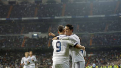 Real Madrid's Cristiano Ronaldo from Portugal, right, celebrates with team mate Karim Benzema from France after scoring a goal during a Copa del Rey soccer match against Celta de Vigo at the Santiago Bernabeu stadium in Madrid, Wednesday, Jan. 9, 2013. (AP Photo/Daniel Ochoa de Olza)