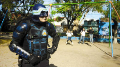 Menganno, an Argentine resident of Lanus dressed as a 'superhero', poses for a picture in Lanus square, province of Buenos Aires, on May 17, 2011. For the last year, Menganno --wearing his mask, suit and protective shield-- has been patrolling the streets of his neighbourhood in his motorbike. AFP PHOTO / Maxi Failla