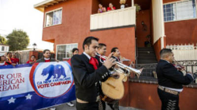 Members of the mariachi band 'Gallos de Jalisco' serenade California citizens to get out and cast their vote on Tuesday, Nov. 6, 2012 in the Sun Valley district of Los Angeles. After a grinding presidential campaign President Barack Obama and Republican presidential candidate, former Massachusetts Gov. Mitt Romney, yield center stage to American voters Tuesday for an Election Day choice that will frame the contours of government and the nation for years to come. (AP Photo/Damian Dovarganes)