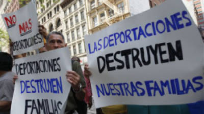 FILE - In this July 15, 2011 file photo, demonstrators hold signs in New York during a rally to condemn an immigration and customs enforcement program known as Secure Communities, and ICE's alleged refusal to meet with directly impacted immigrants. The signs read in Spanish 'Deportations destroy our families.' Despite some changes in policy that might reduce the impact of the program in the United States, Secure Communities is still very active. It has facilitated the deportation of 247,000 immigrants since the program was first activated in a Texas county in 2008. Immigration officials announced that they would not issue 'detainers,' or orders for local police departments to retain certain immigrant suspects, if the person arrested had committed petty crimes like traffic offenses. Groups who defend immigrant rights, however, have reacted with skepticism to the announcement. (AP Photo/Mary Altaffer, File)