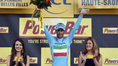 Stage winner Italy's Vincenzo Nibali celebrates on the podium after winning the 161.50 km tenth stage of the 101st edition of the Tour de France cycling race on July 14, 2014 between Mulhouse and La Planche des Belles Filles ski resort, eastern France. AFP PHOTO / ERIC FEFERBERG