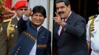 (FILES) In this file photo taken on March 5, 2017 Venezuelan President Nicolas Maduro (R) and Bolivian President Evo Morales gesture during the Bolivarian Alliance for the Peoples of Our America (ALBA) summit at the Miraflores presidential palace in Caracas. - Bolivian President Evo Morales resigned on November 10, 2019, caving in following three weeks of sometimes-violent protests over his disputed re-election after the army and police withdrew their backing. (Photo by Federico PARRA / AFP)