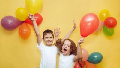 Happy children with balloons at happy birthday party.