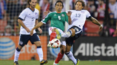 El jugador de la selección de México, Fernando Arce disputa la pelota con Jermaine Jones de Estados Unidos.