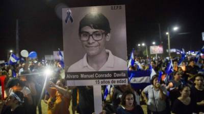 Una mujer sostiene una fotografía de un joven de 15 años de edad que fue asesinado en las pasadas manifestaciones, durante una marcha contra el Gobierno del presidente Daniel Ortega. EFE/Archivo