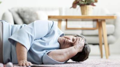 Senior woman with heart attack and headache fall down at home