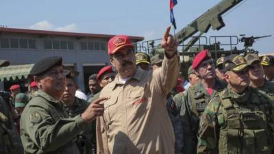Handout picture released by the Venezuelan presidency showing Venezuela's President Nicolas Maduro (C) speaking to a commander during military exercises at the Naval Base Agustin Armario in Puerto Cabello, Carabobo State, Venezuela, on January 27, 2019. - Maduro on Sunday rejected a European ultimatum that he call elections as opposition rival Juan Guaido stepped up appeals to the military to turn against the leftist government. (Photo by HO / Venezuelan Presidency / AFP) / RESTRICTED TO EDITORIAL USE - MANDATORY CREDIT 'AFP PHOTO / VENEZUELAN PRESIDENCY' - NO MARKETING NO ADVERTISING CAMPAIGNS - DISTRIBUTED AS A SERVICE TO CLIENTS