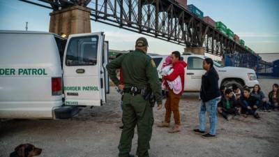 A group of about 30 Brazilian migrants, who had just crossed the border, get into a US Border Patrol van, taking them off the property of Jeff Allen, who used to run a brick factory near Mt. Christo Rey on the US-Mexico border in Sunland Park, New Mexico on March 20, 2019. - The militia members say they will patrol the US-Mexico border near Mt. Christo Rey, 'Until the wall is built.' In recent months, thousands of Central Americans have arrived in Mexico in several caravans in the hope of finding a better life in the United States. US President Donald Trump has branded such migrants a threat to national security, demanding billions of dollars from Congress to build a wall on the southern US border. (Photo by Paul Ratje / AFP)PAUL RATJE/AFP/Getty Images