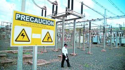 Un guardia camina frente a una estación de transmisión de energía de la Enee. Foto: Andro Rodríguez