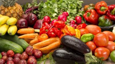 Fresh organic vegetables and fruits on wood table. Horizontal composition.