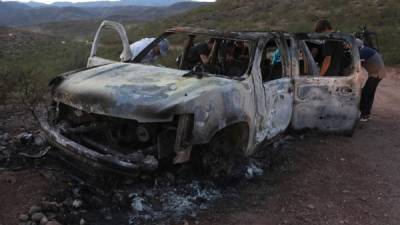 CORRECTION - Members of the Lebaron family watch the burned car where part of the nine murdered members of the family were killed and burned during an gunmen ambush on Bavispe, Sonora mountains, Mexico, on November 5, 2019. - US President Donald Trump offered Tuesday to help Mexico 'wage war' on its cartels after three women and six children from an American Mormon community were murdered in an area notorious for drug traffickers. (Photo by Herika MARTINEZ / AFP) / The erroneous mention[s] appearing in the metadata of this photo by Herika MARTINEZ has been modified in AFP systems in the following manner: [AFP PHOTO / Herika MARTINEZ ] instead of [AFP PHOTO / STR ]. Please immediately remove the erroneous mention[s] from all your online services and delete it (them) from your servers. If you have been authorized by AFP to distribute it (them) to third parties, please ensure that the same actions are carried out by them. Failure to promptly comply with these instructions will entail liability on your part for any continued or post notification usage. Therefore we thank you very much for all your attention and prompt action. We are sorry for the inconvenience this notification may cause and remain at your disposal for any further information you may require.