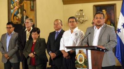 El presidente Juan Orlando Hernández, al lado derecho de blanco, junto a los miembros de la Comisión Depuradora de la Policía Nacional.