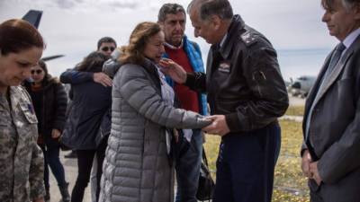 Pilots get off a F-16 plane after combing waters off the southern tip of South America searching for the Chilean Air Force C-130 Hercules cargo plane that went missing with 38 people aboard, at Chabunco army base in Punta Arenas, Chile, on December 12, 2019. - Chile confirmed Thursday that human remains and debris found by search ships are from a military plane reported missing with 38 people aboard, and the chances of finding survivors is 'practically impossible.' (Photo by PABLO COZZAGLIO / AFP)