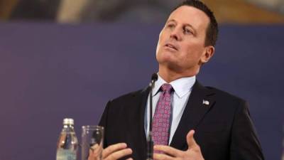 (FILES) In this file photo taken on February 14, 2020 US Ambassador to Germany Richard Grenell (C) gestures during the signing of an agreement between Kosovo and Serbia for railway and street projects at the Munich Security Conference (MSC) in Munich, southern Germany. - President Donald Trump's administration insisted on February 20,2020 that new US intelligence chief Richard Grenell would serve without a partisan agenda as Democrats voiced outrage at placing the voluble Trump defender in the key post. Grenell, the ambassador to Germany where his blunt criticism of the government irritated the close ally, was named late Wednesday by Trump as acting director of national intelligence. (Photo by THOMAS KIENZLE / AFP)