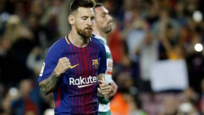 Barcelona's forward from Argentina Lionel Messi celebrates after scoring during the Spanish league football match FC Barcelona against SD Eibar at the Camp Nou stadium in Barcelona on September 19, 2017. / AFP PHOTO / PAU BARRENA