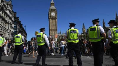 Oficiales de policía monitorean a los manifestantes en las calles de Londres.