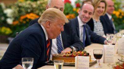 TOPSHOT - A handout photo taken by Ministry of Communications and Information of Singapore on June 11, 2018 shows US President Donald Trump (L) blows a candle after being presented a cake during a working lunch with Singapore's Prime Minister Lee Hsien Loong (not pictured) during his visit to The Istana, the official residence of the prime minister, in Singapore.Kim Jong Un and Donald Trump will meet on June 12 for an unprecedented summit in an attempt to address the last festering legacy of the Cold War, with the US President calling it a 'one time shot' at peace. / AFP PHOTO / Ministry of Communications and Information of Singapore AND AFP PHOTO / Handout / RESTRICTED TO EDITORIAL USE - MANDATORY CREDIT 'AFP PHOTO / Ministry of Communications and Information of Singapore' - NO MARKETING NO ADVERTISING CAMPAIGNS - DISTRIBUTED AS A SERVICE TO CLIENTS - NO ARCHIVES