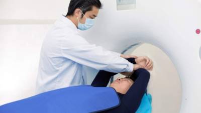 Radiologist with a patient at MRI scan