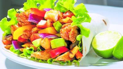 Close up of a kebab with chicken coated with breadcrumbs