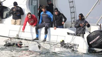 Fotografía cedida por Discovery en Español, fechada el martes 11 de julio de 2017, en donde se muestra al nadador olímpico estadounidense Michael Phelps (c), en un barco antes de nadar con un tiburón blanco, en Ciudad del Cabo (Sudáfrica). EFE/Discovery en Español