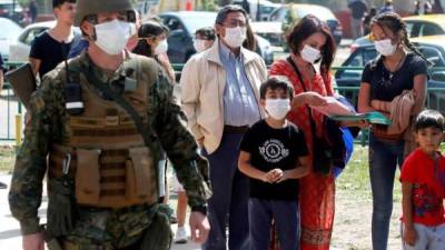 Un grupo de personas hacen fila para vacunarse contra la influenza en el Estadio Bicentenario de la Florida este sábado, en Santiago (Chile). EFE