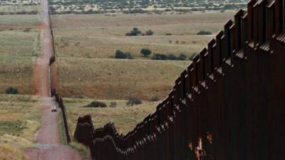 (FILES) In this file photo taken on January 6, 2019 a section of the reinforced US - Mexico border fence on the Otay Mesa area, San Diego County, as seen from Tijuana, in Baja California state, Mexico. - Facing stiff resistance from Congress, President Donald Trump has said he might use his emergency powers to construct hundreds of miles of wall on the southern border to prevent migrants from crossing into the United States illegally from Mexico. Trump could indeed declare a national emergency, citing what the administration calls a 'crisis' at the border, after nearly 103,000 people were detained in October and November after entering the country illegally.But trying to build a wall in this way would face significant legal barriers. (Photo by Guillermo Arias / AFP)