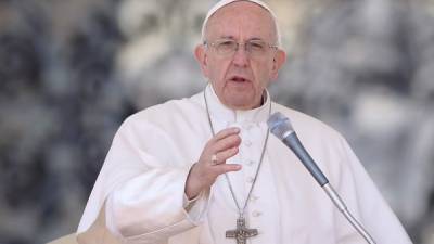 Pope Francis blesses the crowd at the end of a weekly general audience at St Peter's square on April 5, 2017 in Vatican. Pope Francis on Wednesday condemned a suspected chemical weapons attack in Syria that left more than 70 dead in a rebel-held town as an 'unacceptable massacre'. 'We watch horrified as the latest events in Syria unfold,' Francis said at his midweek public audience in St Peter's square. / AFP PHOTO / Filippo MONTEFORTE