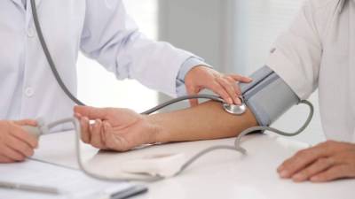 Doctor checking blood pressure of the patient
