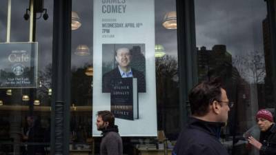 NEW YORK, NY - APRIL 17: An advertisement for a book signing event with former FBI Director James Comey, featuring his new book 'A Higher Loyalty: Truth, Lies, and Leadership, 'is displayed in the window Barnes & Noble bookstore, April 17, 2018 in New York City. The book, which goes on sale today, focuses on leadership principles and details his interactions with President Donald Trump. Comey served as FBI Director from September 2013 until May 2017, when he was fired by President Donald Trump. Previously, Comey had also served as U.S. Deputy Attorney General and U.S. Attorney for the Southern District of New York. Drew Angerer/Getty Images/AFP== FOR NEWSPAPERS, INTERNET, TELCOS & TELEVISION USE ONLY ==