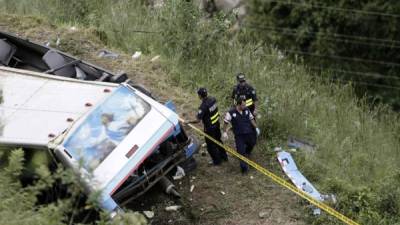 Miembros de la fuerza pública de Costa Rica examinan el sitio de un accidente de un autobús de turistas, en Cinchona (Costa Rica), ayer jueves 20 de octubre de 2016. EFE