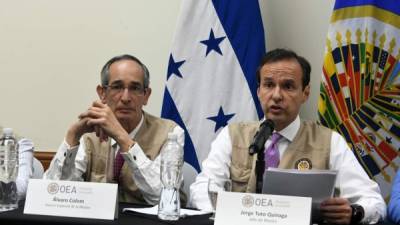The chief of the Organization of American States mission, Jorge Tuto Quiroga (D) and Alvaro Colom (L) answer questions during a press conference about the national elections in Tegucigalpa, on December 17, 2017. The Organization of American States called for calm. Honduran President Juan Orlando Hernandez was declared the winner of a heavily disputed presidential election held three weeks ago, despite mounting protests and opposition claims of fraud.Electoral authorities made the announcement the day that Hernandez's leftist opponent, Salvador Nasralla, departed for the United States to highlight what he said was ballot tampering in the November 26 poll. / AFP PHOTO / ORLANDO SIERRA