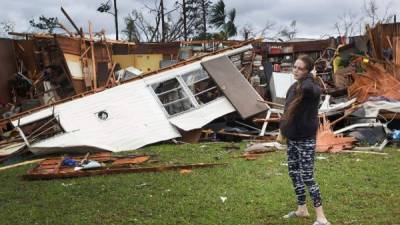 PANAMA CITY, FL - OCTOBER 10: Haley Nelson stands in front of what is left of one of her fathers trailer homes after hurricane Michael passed through the area on October 10, 2018 in Panama City, Florida. The hurricane hit the Florida Panhandle as a category 4 storm. Joe Raedle/Getty Images/AFP