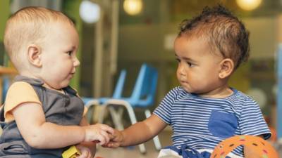 Babys playing together in the kindergarten.