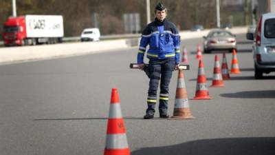 Un miembro de la policía francesa controla la carretera que conecta París con las localidades de Senils y Compiègne, Francia. EFE