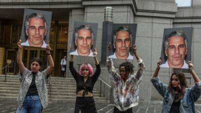 NEW YORK, NY - JULY 08: A protest group called 'Hot Mess' hold up signs of Jeffrey Epstein in front of the Federal courthouse on July 8, 2019 in New York City. According to reports, Epstein will be charged with one count of sex trafficking of minors and one count of conspiracy to engage in sex trafficking of minors. Stephanie Keith/Getty Images/AFP