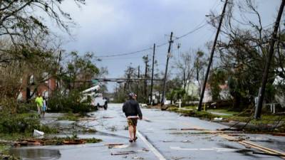 Un hombre camina por las calles de Panama City, afectada por el huracán Michael.