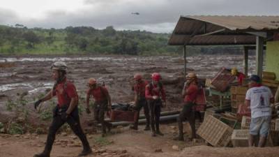 A body is recovered by Minas Gerais firefighters from a small market at the mud-hit area a day after the collapse of a dam at an iron-ore mine belonging to Brazil's giant mining company Vale near the town of Brumadinho in the state of Minas Gerais in southeastern Brazil, on January 26, 2019. - Hopes were fading Saturday that rescuers would find more survivors from at least 300 missing after a dam collapse at a mine in southeastern Brazil, with nine bodies so far recovered. (Photo by Mauro Pimentel / AFP)