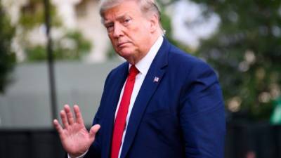 US President Donald Trump waves as he arrives at the White House in Washington, DC, August 21, 2019. (Photo by JIM WATSON / AFP)